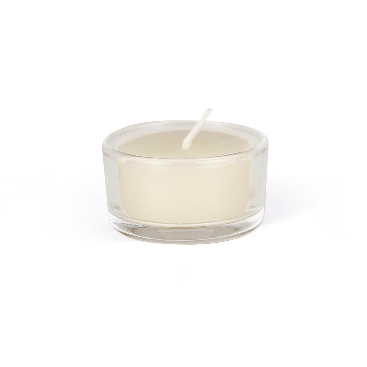 A small, cream-coloured tea light candle in a flat, round glass container against a white background. The wick is visible in the centre and protrudes from the smooth, unused wax. The transparent container is cylindrical.