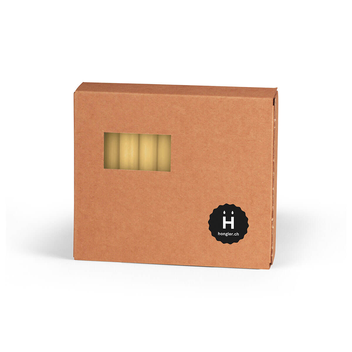 A square, brown cardboard box stands on a white surface. A rectangular window reveals several amber-coloured Christmas tree candles. A round, black sticker featuring a white ‘H’ and ‘Hongler.ch’ is affixed to it.