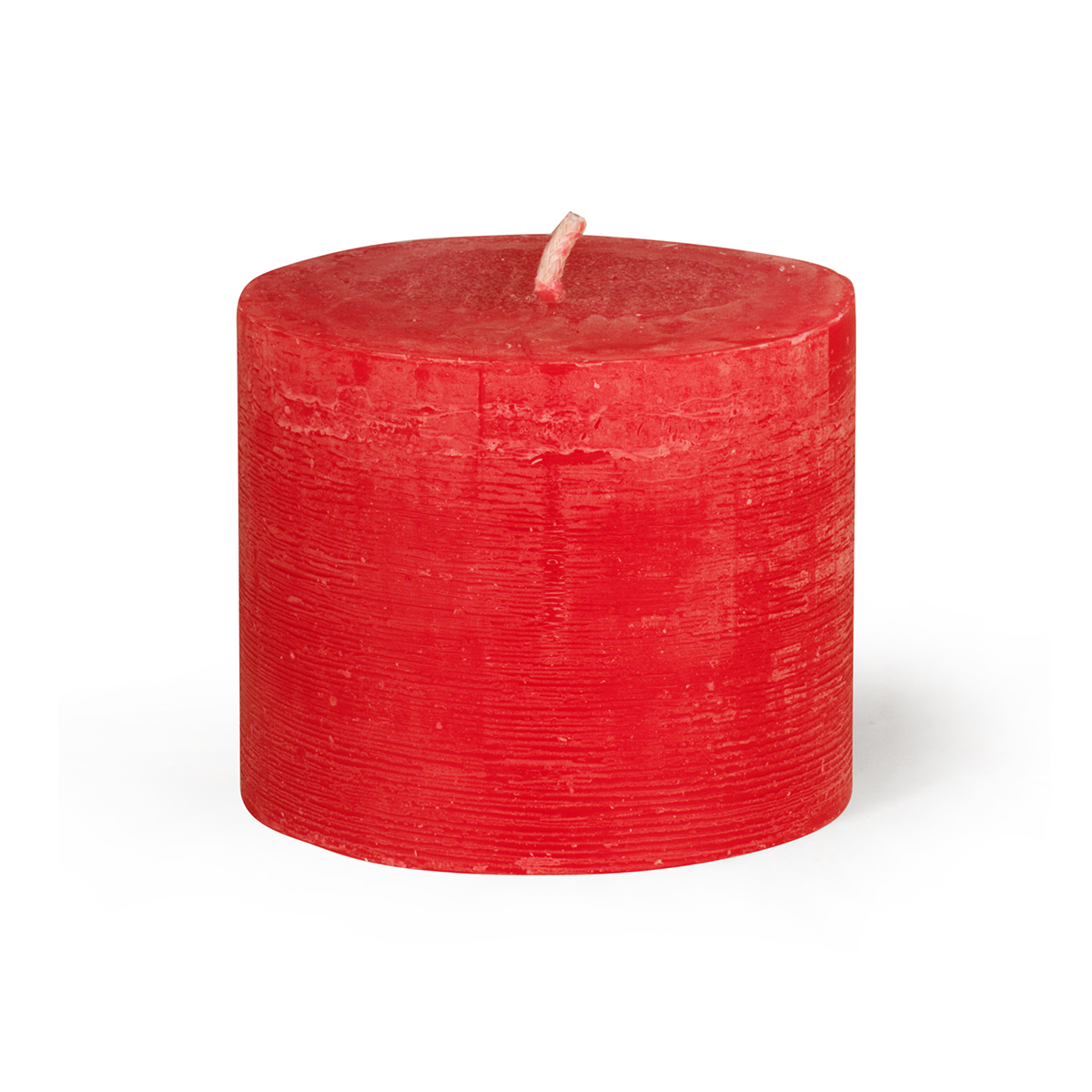 A red, cylindrical pillar candle with a white wick, standing on a white background and casting a faint shadow. The surface of the candle is slightly rough with horizontal lines.