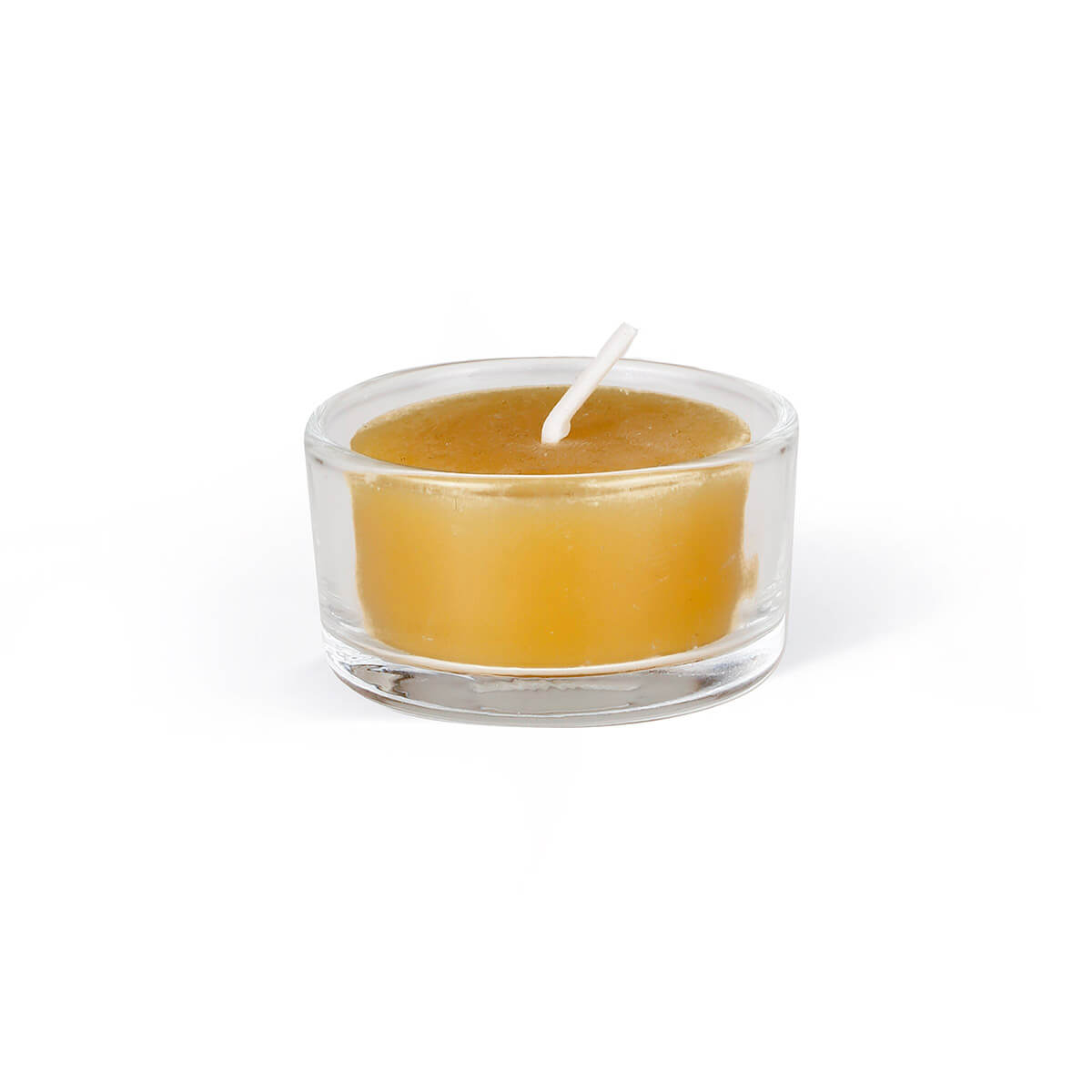 Round tea light candle in a transparent glass cup, isolated against a pure white background. Warm golden-yellow wax, white wick standing straight and unlit in the centre. Subtle reflections of light in the glass, delicate shadows.