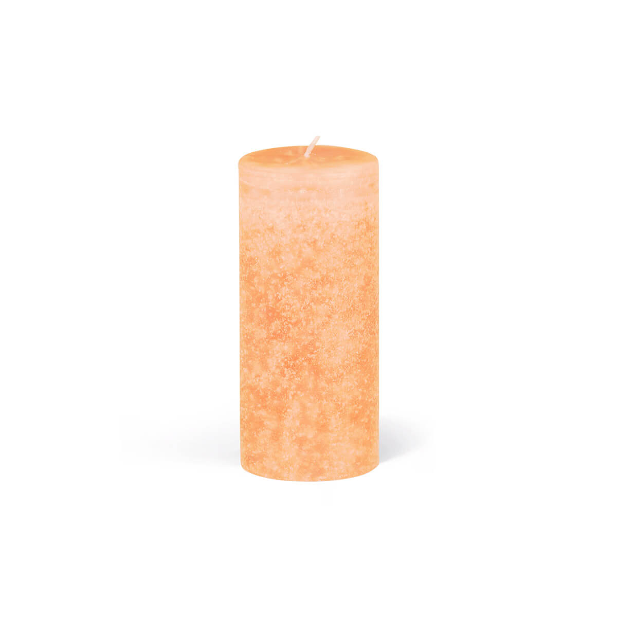 A single, cylindrical pillar candle in a delicate apricot shade stands against a white background. The candle has a slightly uneven texture and a wick in the centre.