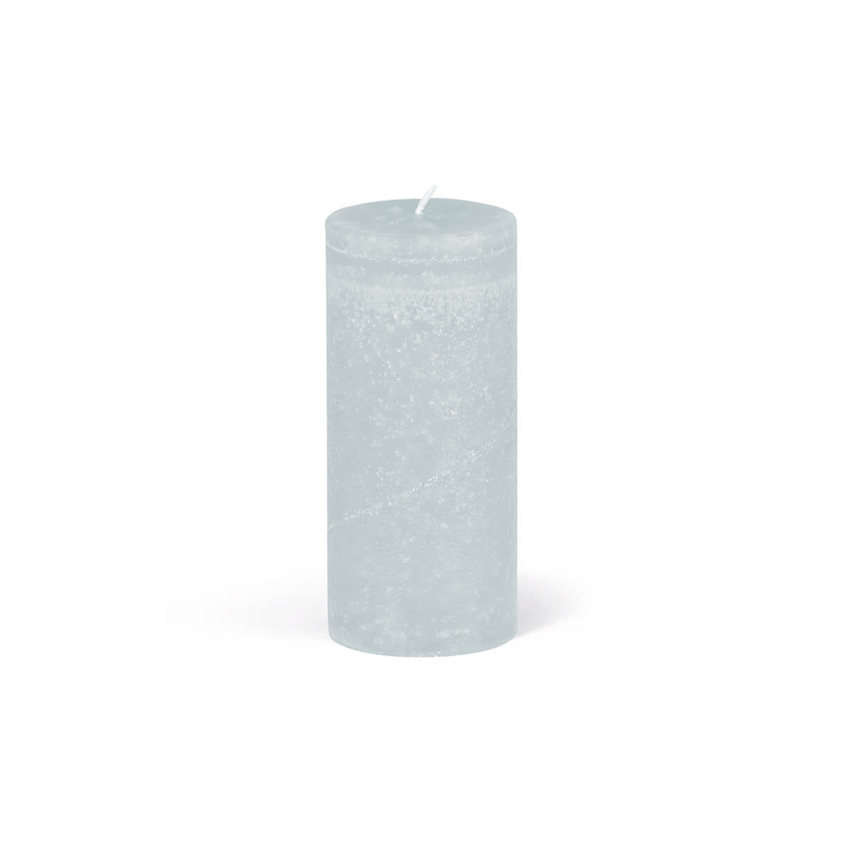 A cylindrical, light blue pillar candle with a white wick positioned in the centre stands on a white surface. The surface of the candle has a slightly textured, marbled finish.