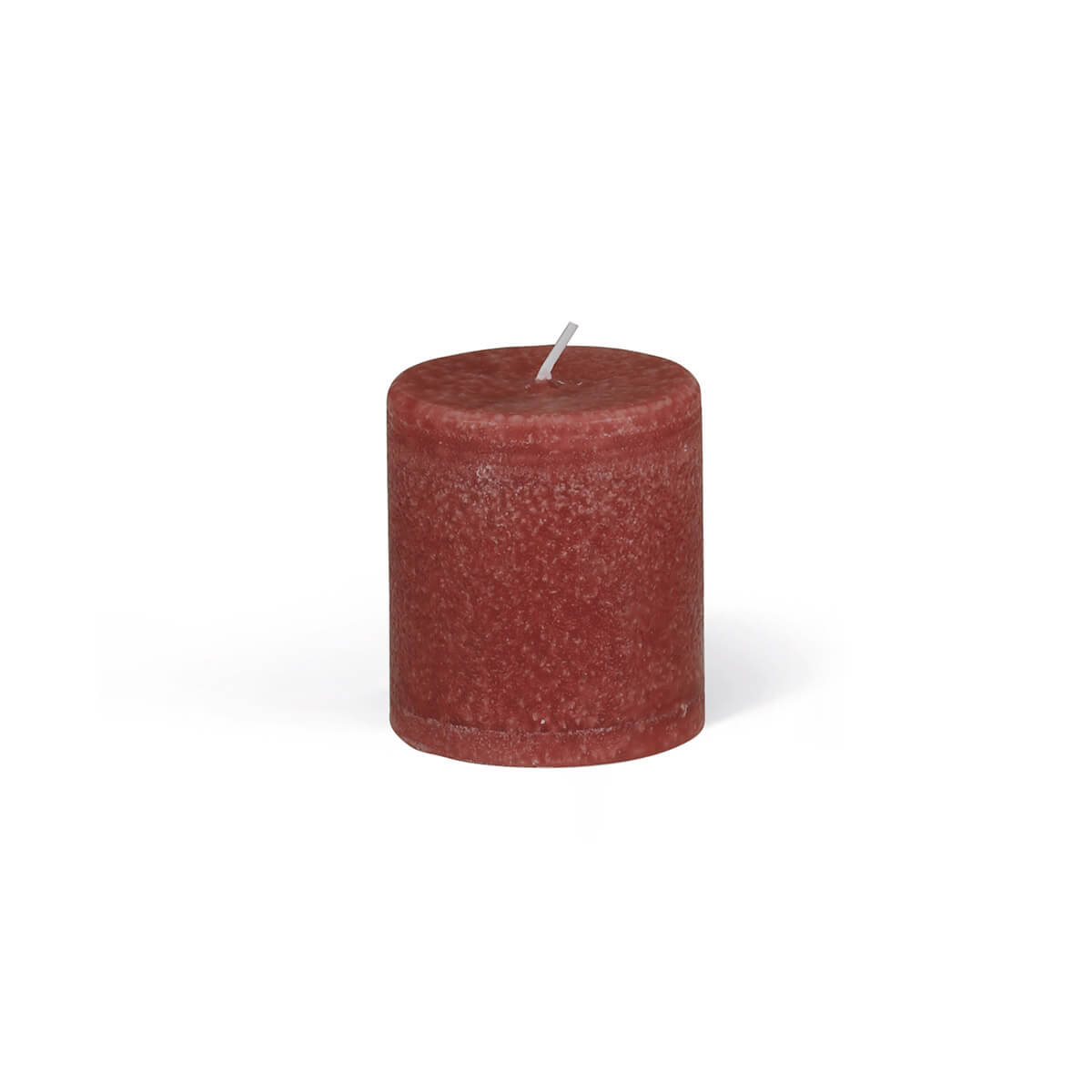 A freestanding, cylindrical pillar candle in a deep, earthy shade of red. The surface is slightly textured, with a short, white wick protruding from the centre. The shadow suggests a light source from above.